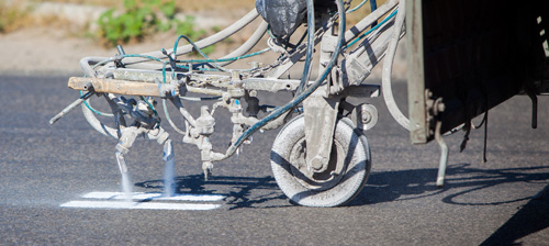 Road marking machine painting lines on the road
